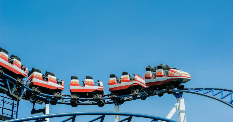 Rides - Red and White Roller Coaster on Railings