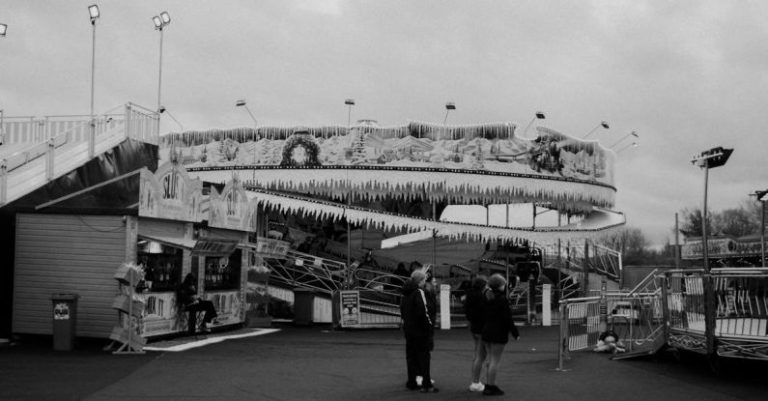 Rides - Black and white photo of people walking on a rainy day