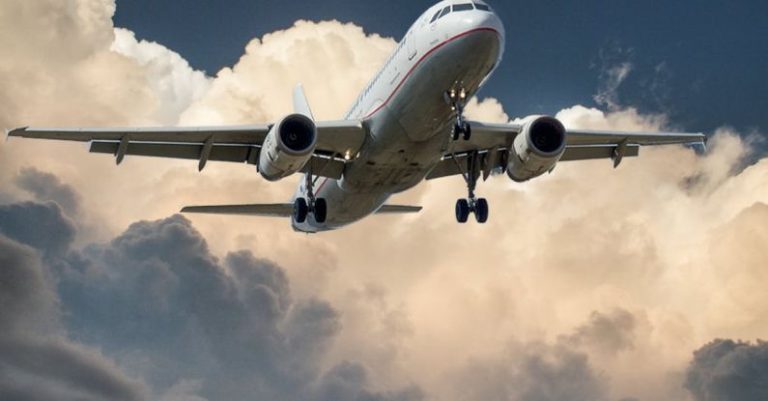 Flights - White and Red Plane Beside Clouds Low-angle Photography