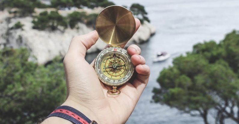 Tour - Person Holding Compass