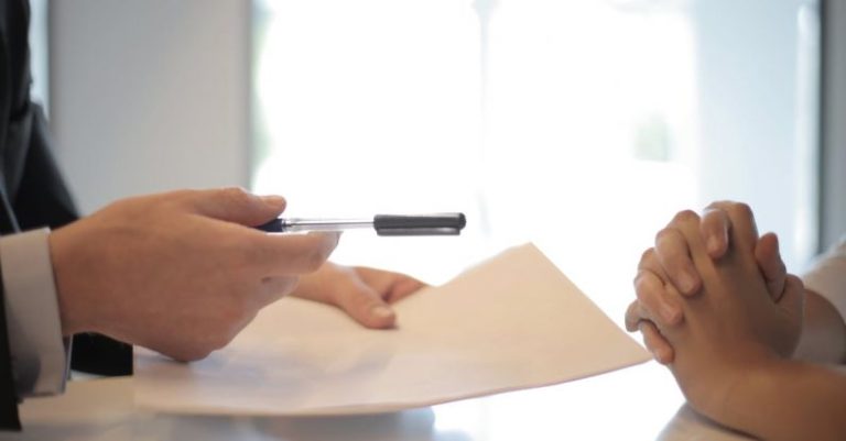 Insurance - Crop businessman giving contract to woman to sign