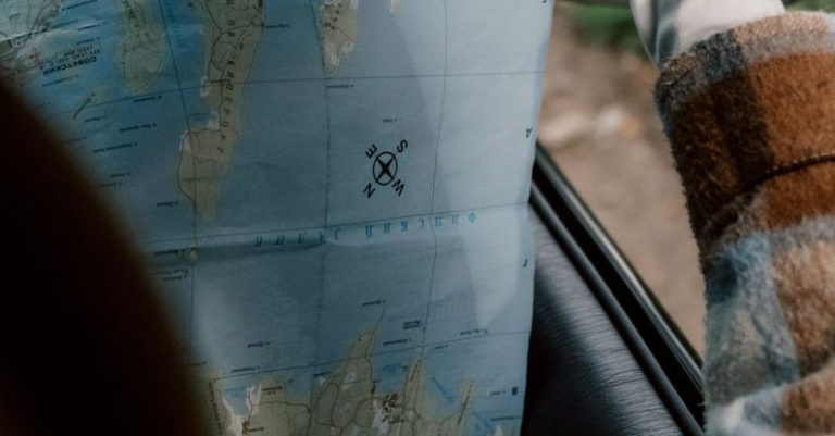 Itineraries - Person in Plaid Long Sleeve Shirt Holding a Map