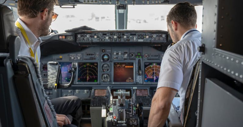 Pilots - Two Pilots Sitting Inside Plane