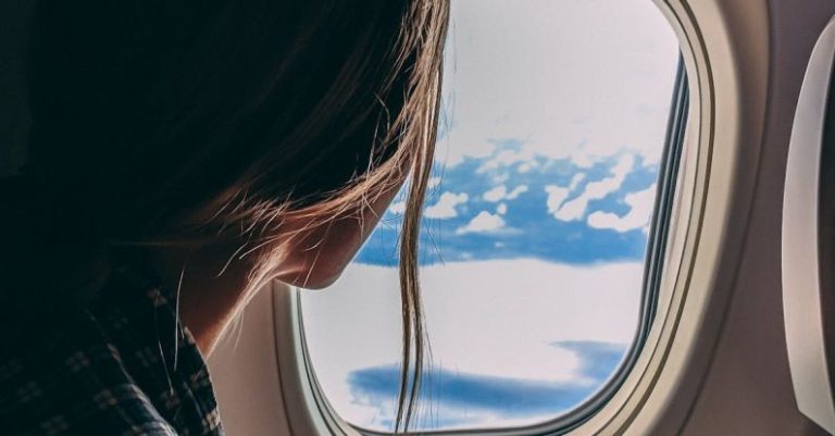 Flights - Person Holding Smartphone Riding Airplane