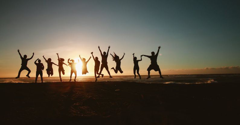 Community - Silhouette Photography of Group of People Jumping during Golden Time