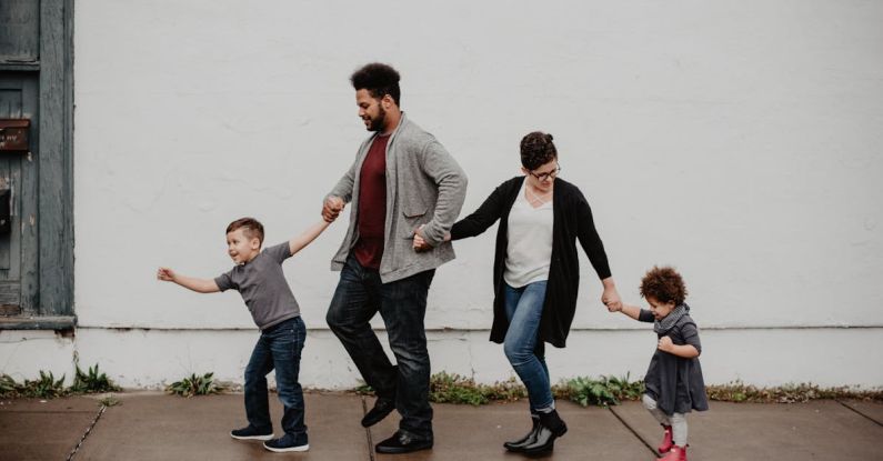 Families - Family Of Four Walking At The Street